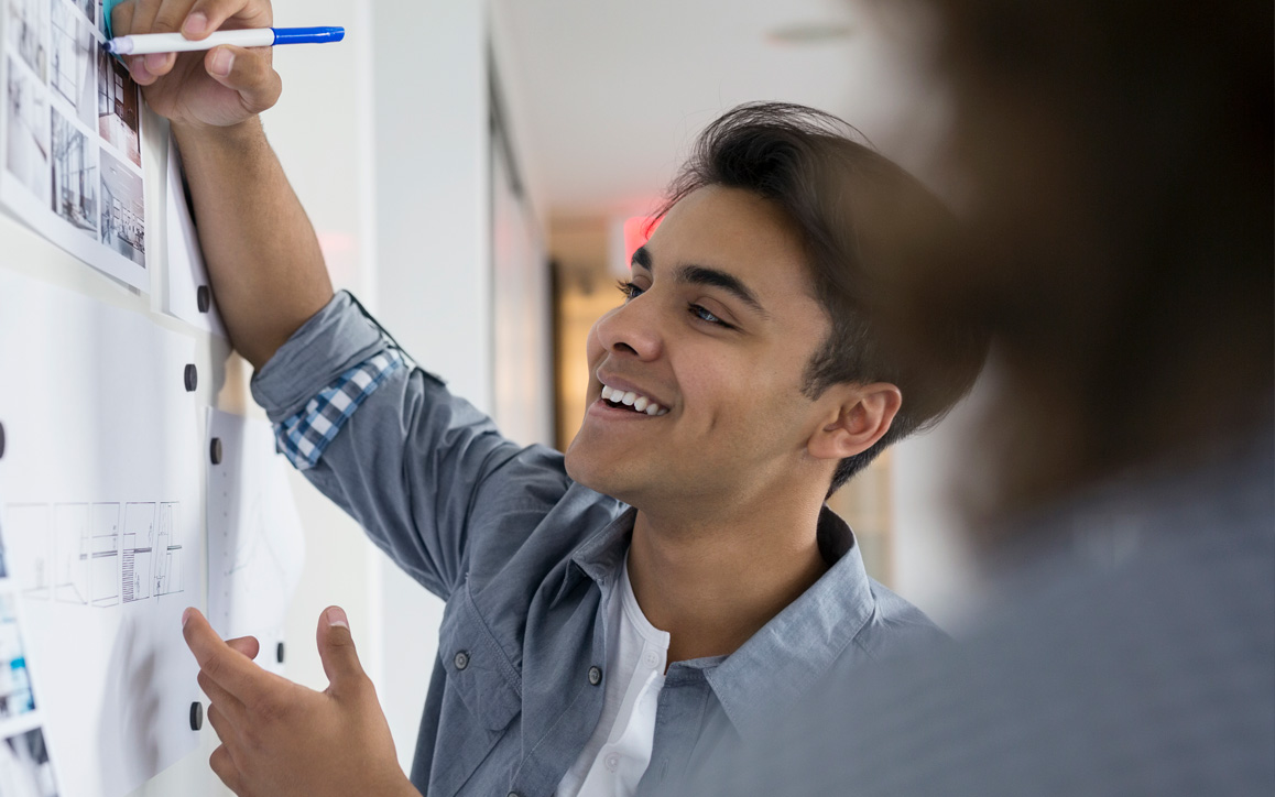 Employee drawing on white board