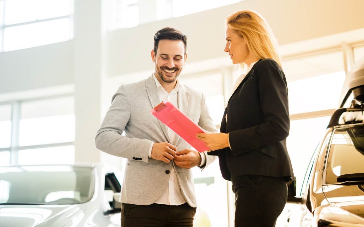 Man and women in automotive showroom