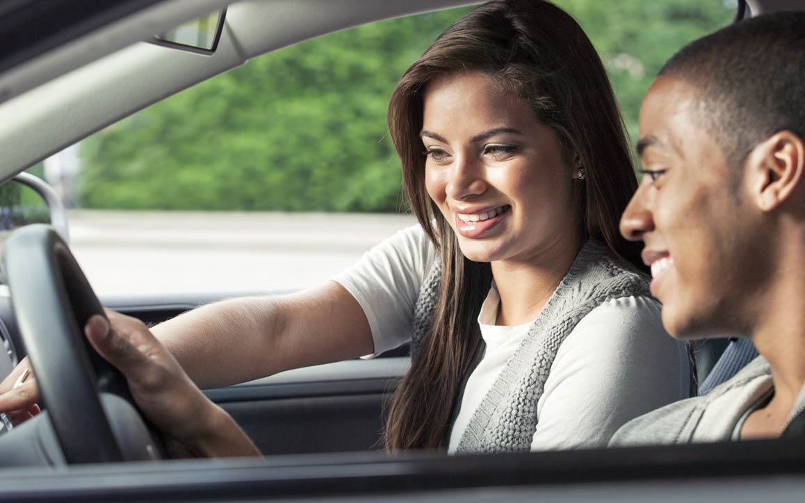 aot_SPW_connected_services Man and woman use touchscreen technology in car