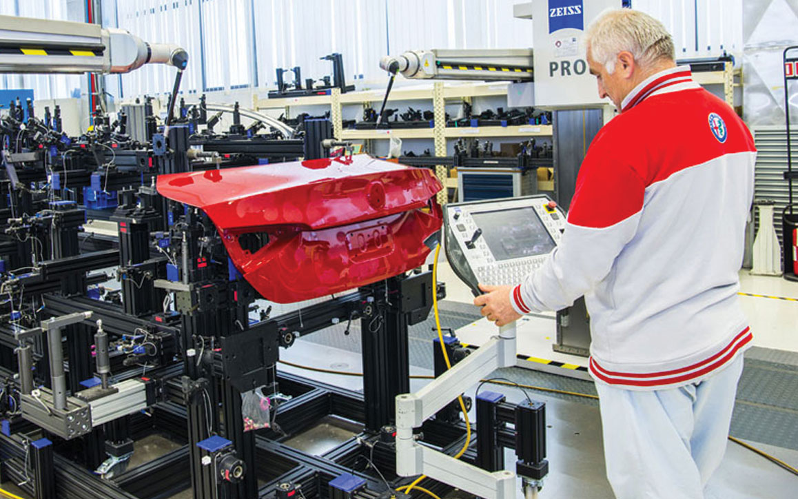 An employee ensures quality of powertrain components