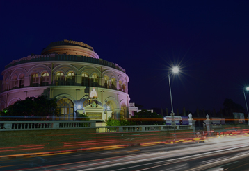 Vivekananda House along a quiet road with lights shining on the building.