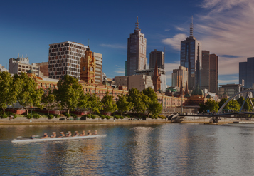 City buildings reflecting off the water along Port Phillip Bay