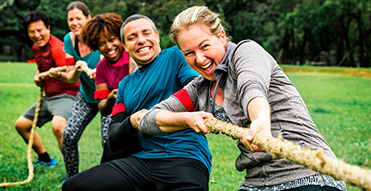 Group of employees playing tug of war